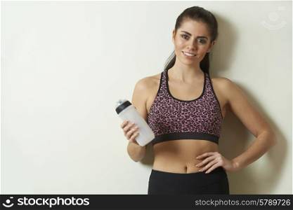 Woman Holding Water Bottle Taking Break During Exercise
