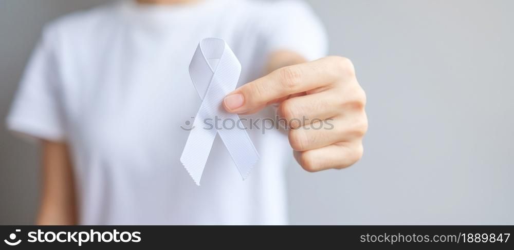 Woman holding white Ribbon for November Lung Cancer Awareness month, democracy and international peace day. Healthcare concept