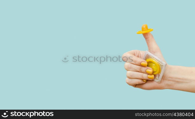woman holding yellow condom her finger