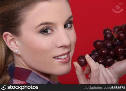 Woman holdingf red grapes