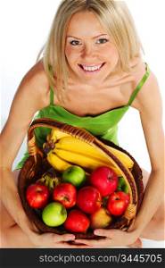 woman holds a basket of fruit on a white background