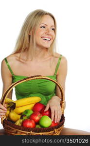 woman holds a basket of fruit on a white background