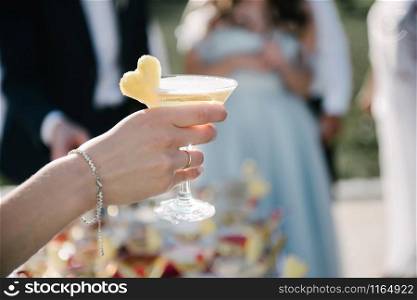 Woman holds a glass with a drink in hand. Woman holds a glass with a drink in hand close up