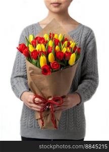 woman holds bouquet of yellow and red tulips related tape . Valentine’s Day. woman holds flowers in hands