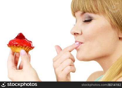 Woman holds cake strawberry cupcake . Woman holds cake cupcake in hand unhealthy food snack. Bakery sweet eating happiness and people concept. Side view