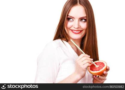 Woman holds grapefruit drinking juice from fruit. Woman attractive long hair girl colorful eyes makeup holding grapefruit citrus drinking juice from fruit. Healthy diet food. Summer vacation holidays concept. Copy space for text