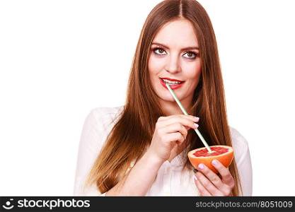 Woman holds grapefruit drinking juice from fruit. Woman attractive long hair girl colorful eyes makeup holding grapefruit citrus drinking juice from fruit. Healthy diet food. Summer vacation holidays concept