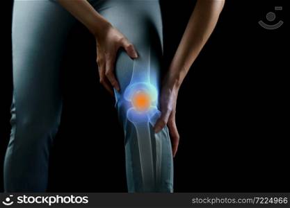 Woman holds her hands to the knee, pain in the knee highlighted in blue, medicine, massage concept.