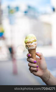 Woman holds ice in her hand, beautiful summer day