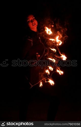 Woman holds in his hand the fire.