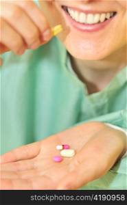 woman holds pills in a hand