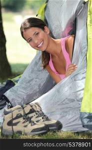 Woman holidaying in a tent