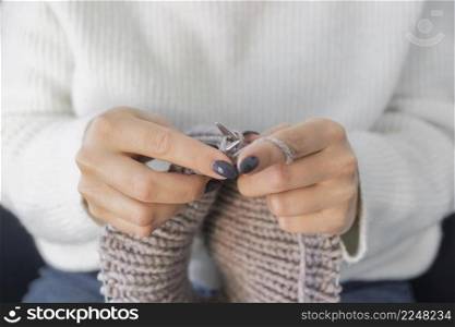 woman home knitting close up