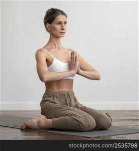 woman home practicing yoga mat