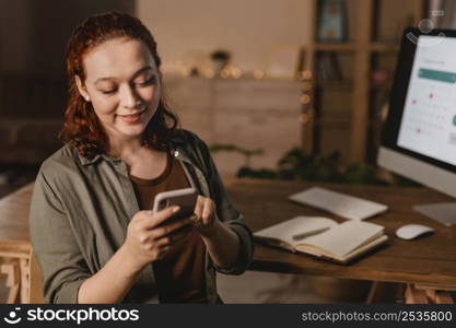 woman home using smartphone front computer
