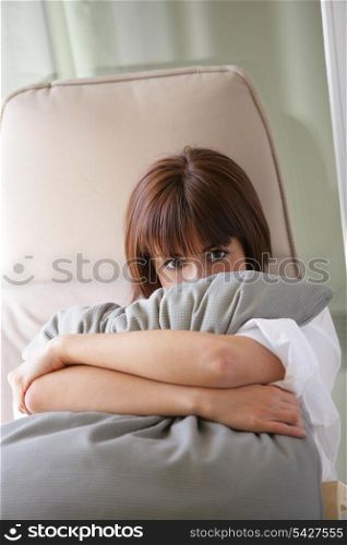 Woman hugging a cushion