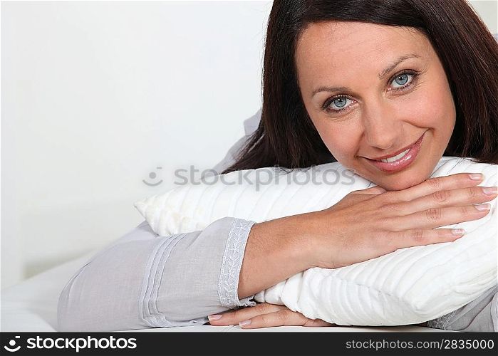 Woman hugging a pillow