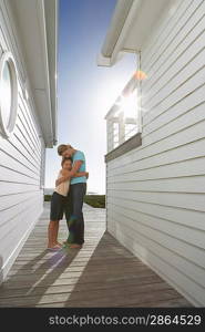 Woman Hugging Daughter on Deck