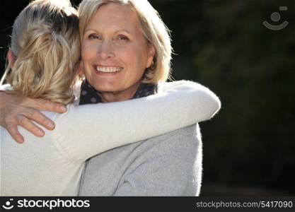 Woman hugging her granddaughter