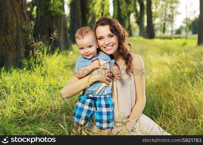 Woman hugging her similing little son