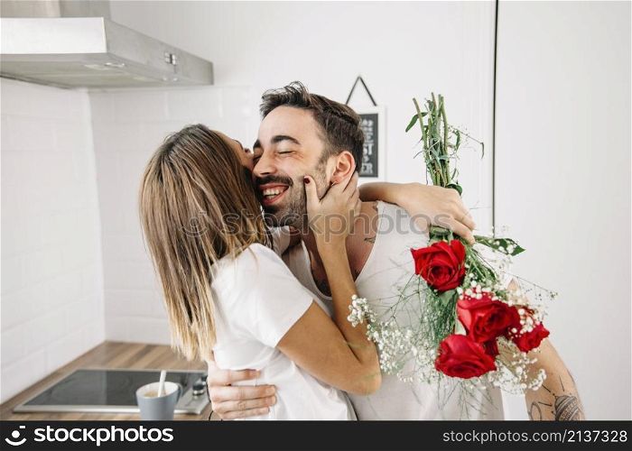 woman hugging man after receiving bouquet