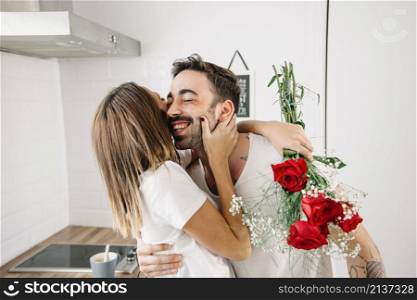 woman hugging man after receiving bouquet