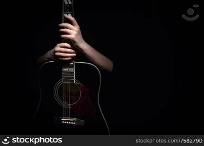 Woman Hugging With Her Hands Guitar, Isolated On Black