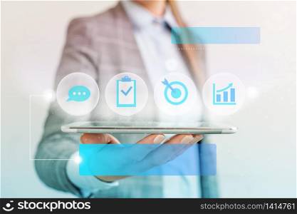 woman icons smartphone computer tablet office supply technological device. Target bar chart talk conversation verify check icons and woman holding a smartphone tablet computer in blue screen. Office business concept technological device.