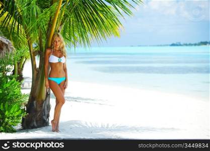 woman in a bikini on a background of palm trees
