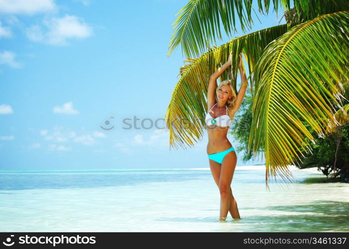 woman in a bikini on a background of palm trees