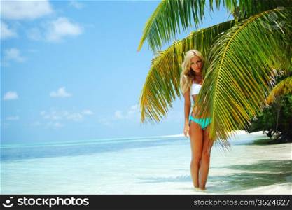 woman in a bikini on a background of palm trees
