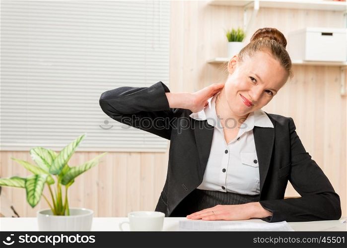 woman in a business suit rubbing his neck, which is sore from working at a computer