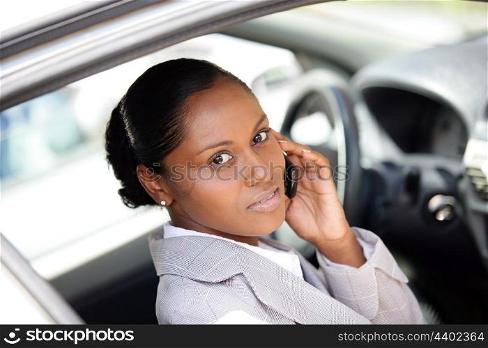 Woman in a car using a cellphone