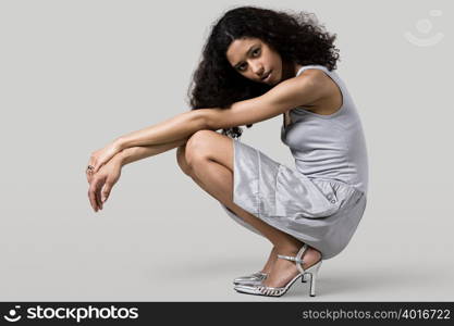 Woman in a dress crouching