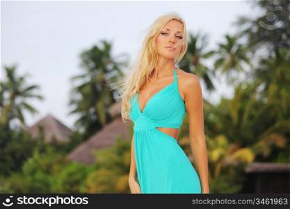 woman in a dress on a background of palm trees