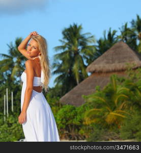 woman in a dress on a background of palm trees