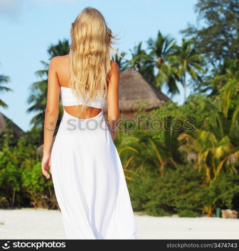 woman in a dress on a background of palm trees