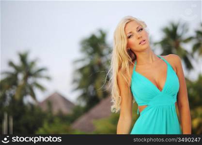 woman in a dress on a background of palm trees