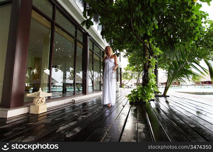 woman in a dress on a bridge home sea