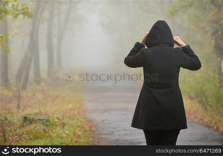 Woman In A Foggy Forest During Autumn