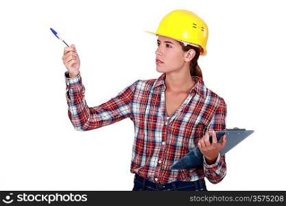 Woman in a hardhat with a clipboard