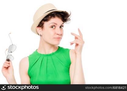 woman in a hat with sunglasses posing in the studio