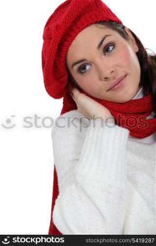 Woman in a knitted jumper, scarf and hat
