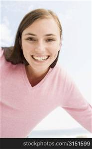 Woman in a pink sweater posing