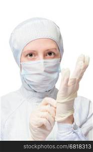woman in a protective suit wears disposable sterile gloves on a white background