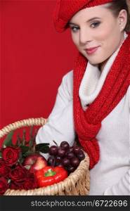 Woman in a red scarf and hat with red food and roses