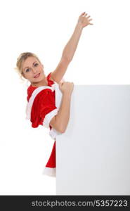 woman in a Santa Claus suit holding a poster