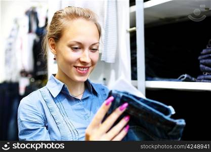 Woman in a shop buying clothes