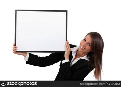 Woman in a smart black suit holding a board left blank for your image or message