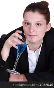 woman in a suit drinking a cocktail